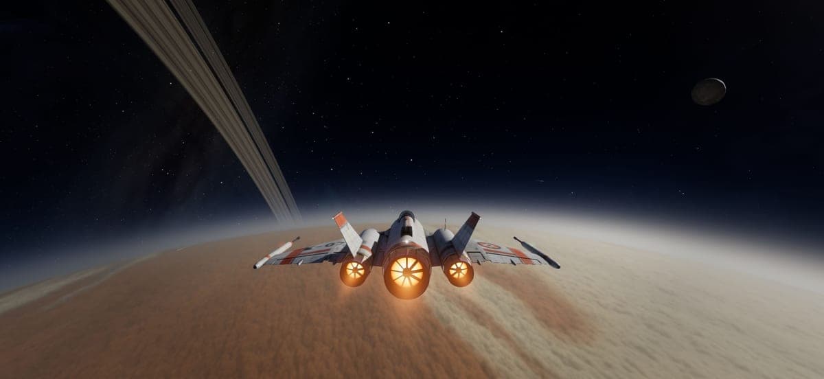 The interceptor skimming Goliath's ochre cloud tops beneath its ring.